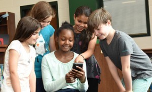 Students looking at Phone Image