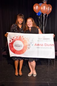 Anna Dunn holds banner with previous winner