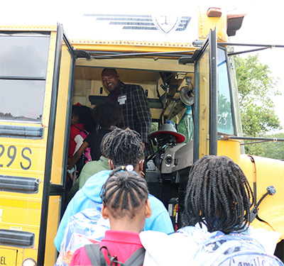 Mr. Frazier in a School Bus with Students